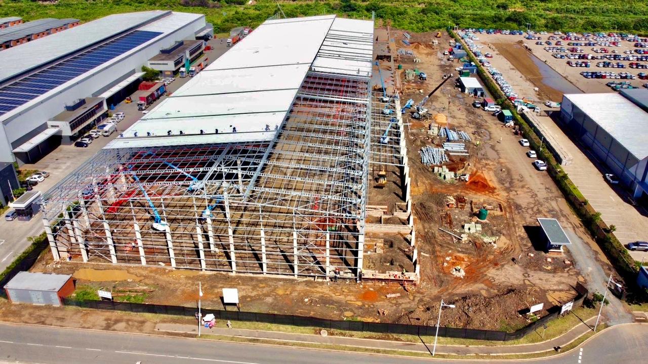 Aerial view of industrial warehouse under construction with fire sprinkler installation by KNS Fire in progress