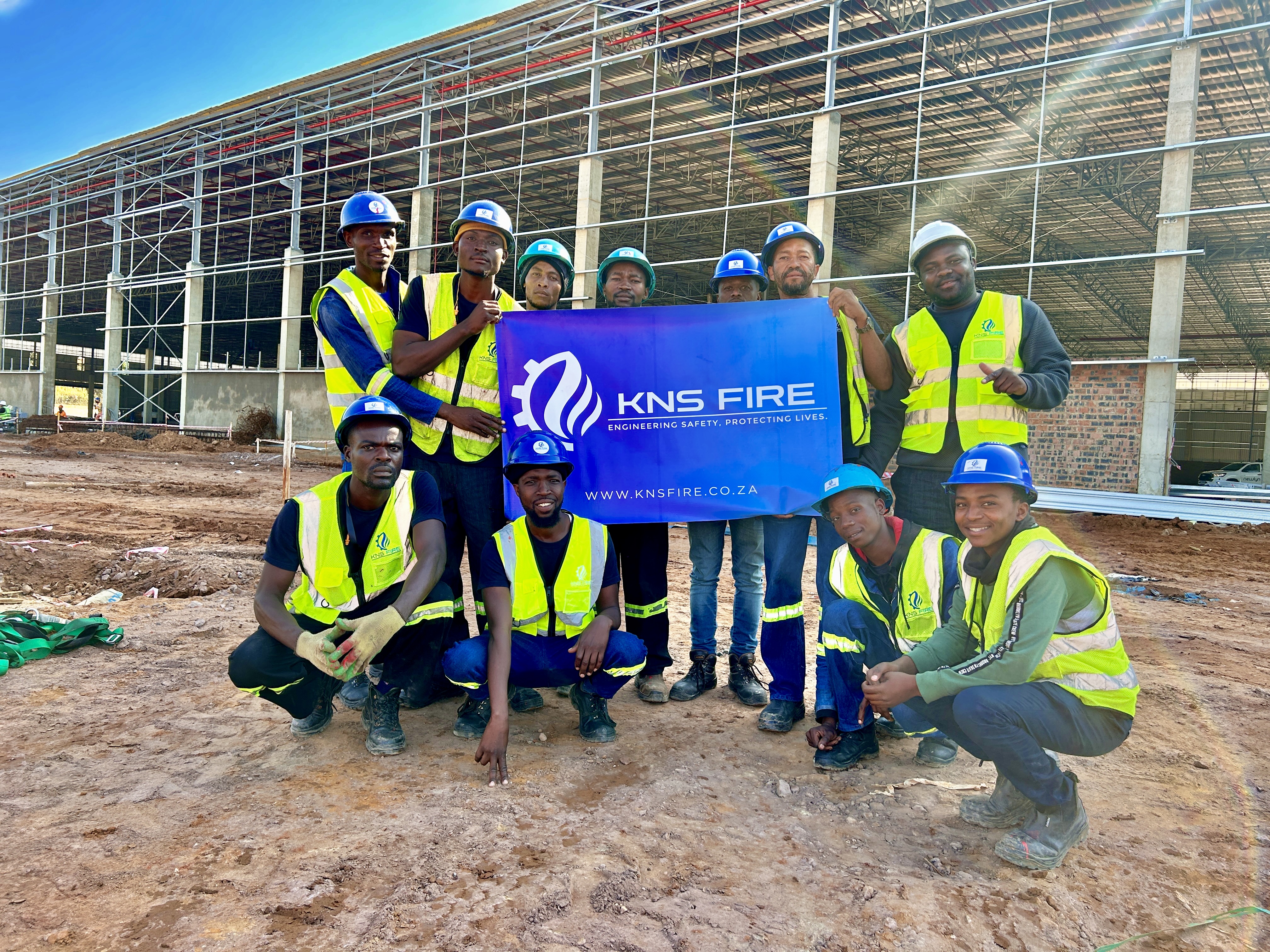 Fire sprinkler system installation by KNS Fire inside a large warehouse during construction phase